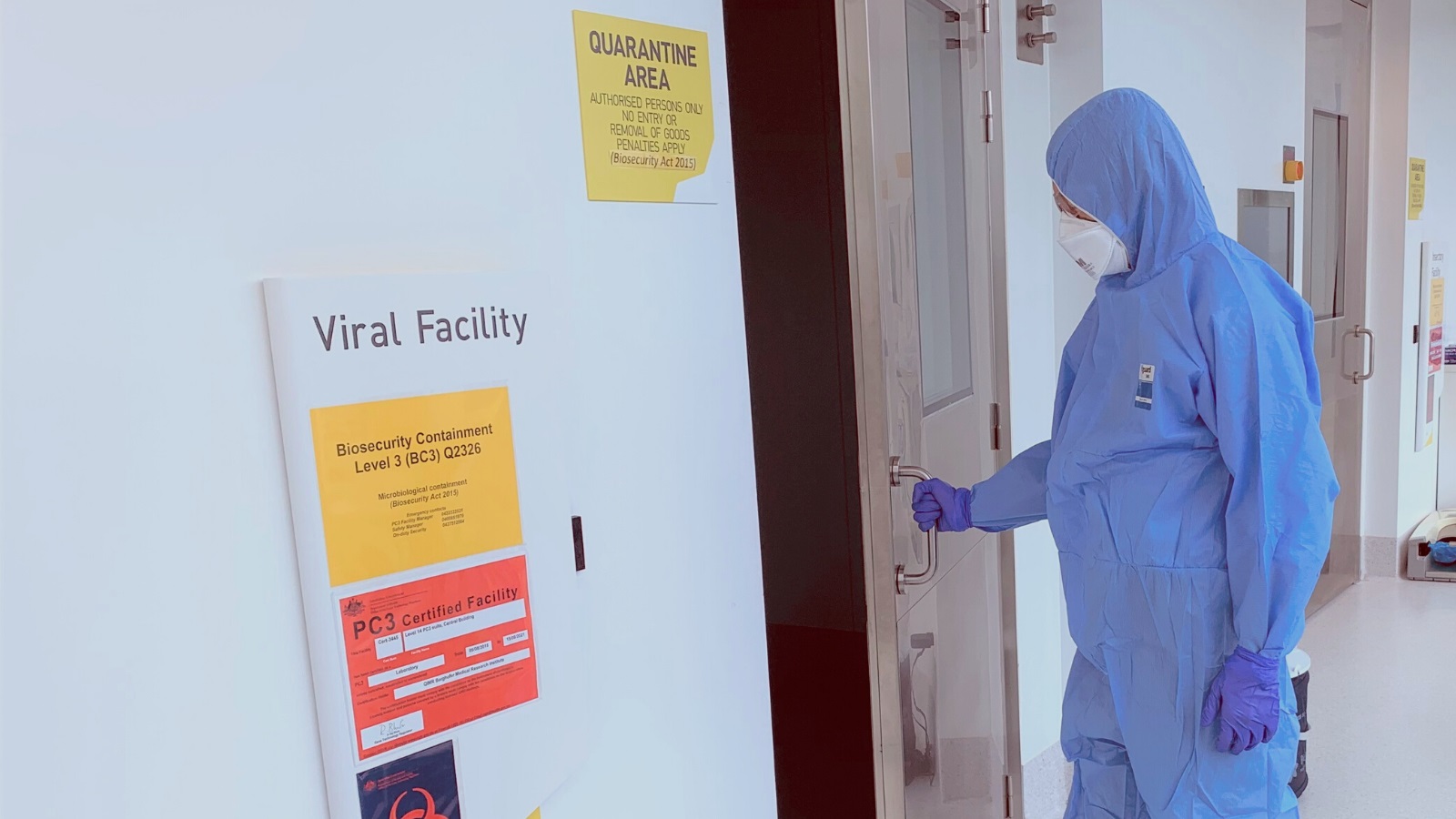 Person in hazmat suit outside virology lab