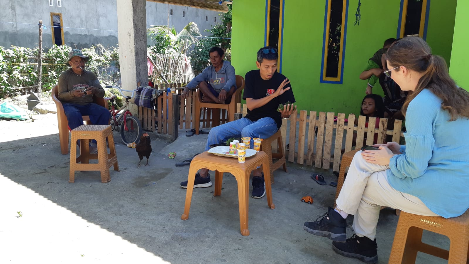 Madeleine sitting with Indonesian researchers