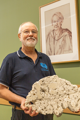 Professor Gregory Webb holding ~5000 year-old Heron Island reefrock containing coral, algae rubble and microbialites.