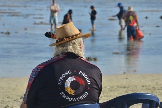 man with back to camera looking at ocean