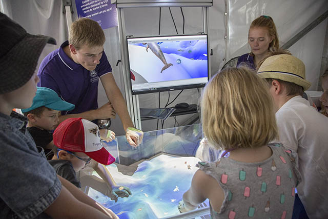 Children interacting with the augmented reality sandbox