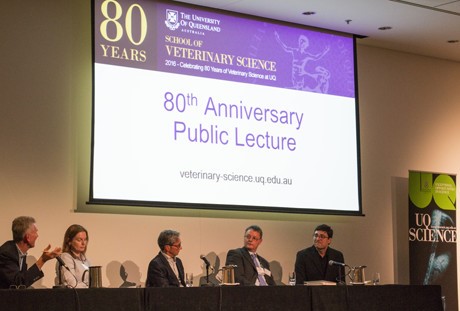 Panel in front of 80th Anniversary sign. 