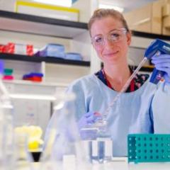 Kirsty Short holding lab equipment