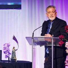 Glenn Denning talks in front of a podium