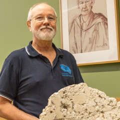 Professor Gregory Webb holding ~5000 year-old Heron Island reefrock containing coral, algae rubble and microbialites.